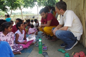 Children study English using the <i>Ollie the Elephant</i> books, at one of the slums in India where Charity United's educational programs are in operation.