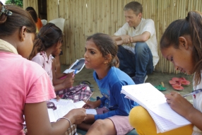 Children study English using the <i>Ollie the Elephant</i> books, at one of the slums in India where Charity United's educational programs are in operation.