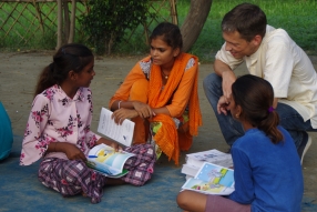 Children study English using the <i>Ollie the Elephant</i> books, at one of the slums in India where Charity United's educational programs are in operation.