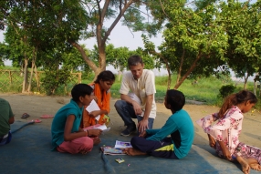 Children study English using the <i>Ollie the Elephant</i> books, at one of the slums in India where Charity United's educational programs are in operation.