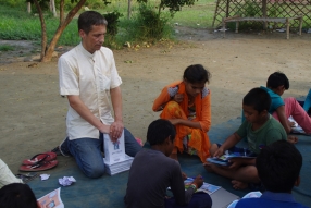Children study English using the <i>Ollie the Elephant</i> books, at one of the slums in India where Charity United's educational programs are in operation.