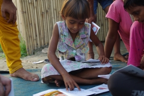 Children study English using the <i>Ollie the Elephant</i> books, at one of the slums in India where Charity United's educational programs are in operation.