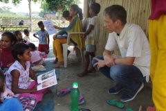 Children study English using the <i>Ollie the Elephant</i> books, at one of the slums in India where Charity United's educational programs are in operation.