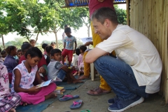 Children study English using the <i>Ollie the Elephant</i> books, at one of the slums in India where Charity United's educational programs are in operation.