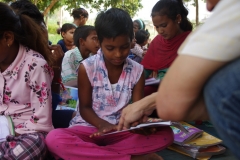 Children study English using the <i>Ollie the Elephant</i> books, at one of the slums in India where Charity United's educational programs are in operation.