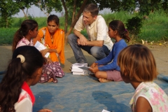 Children study English using the <i>Ollie the Elephant</i> books, at one of the slums in India where Charity United's educational programs are in operation.