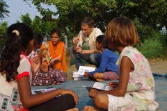 Children study English using the <i>Ollie the Elephant</i> books, at one of the slums in India where Charity United's educational programs are in operation.