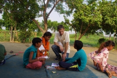 Children study English using the <i>Ollie the Elephant</i> books, at one of the slums in India where Charity United's educational programs are in operation.