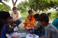 Children study English using the <i>Ollie the Elephant</i> books, at one of the slums in India where Charity United's educational programs are in operation.