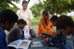 Children study English using the <i>Ollie the Elephant</i> books, at one of the slums in India where Charity United's educational programs are in operation.