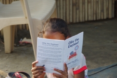 Children study English using the <i>Ollie the Elephant</i> books, at one of the slums in India where Charity United's educational programs are in operation.