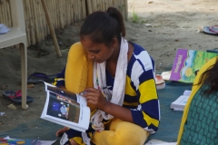 Children study English using the <i>Ollie the Elephant</i> books, at one of the slums in India where Charity United's educational programs are in operation.