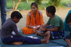 Children study English using the <i>Ollie the Elephant</i> books, at one of the slums in India where Charity United's educational programs are in operation.