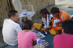 Children study English using the <i>Ollie the Elephant</i> books, at one of the slums in India where Charity United's educational programs are in operation.