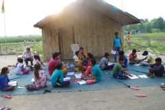 Children study English using the <i>Ollie the Elephant</i> books, at one of the slums in India where Charity United's educational programs are in operation.