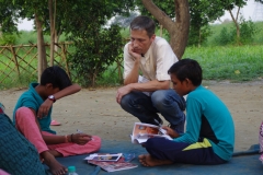 Children study English using the <i>Ollie the Elephant</i> books, at one of the slums in India where Charity United's educational programs are in operation.