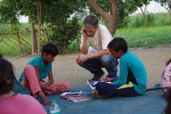 Children study English using the <i>Ollie the Elephant</i> books, at one of the slums in India where Charity United's educational programs are in operation.