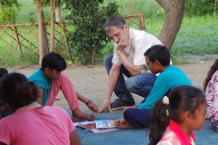 Children study English using the <i>Ollie the Elephant</i> books, at one of the slums in India where Charity United's educational programs are in operation.