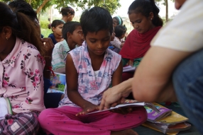 Children study English using the <i>Ollie the Elephant</i> books, at one of the slums in India where Charity United's educational programs are in operation.
