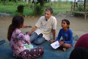 Children study English using the <i>Ollie the Elephant</i> books, at one of the slums in India where Charity United's educational programs are in operation.