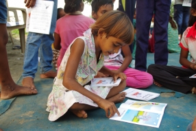 Children study English using the <i>Ollie the Elephant</i> books, at one of the slums in India where Charity United's educational programs are in operation.