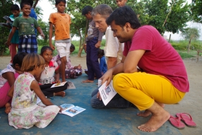 Children study English using the <i>Ollie the Elephant</i> books, at one of the slums in India where Charity United's educational programs are in operation.
