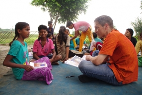 Children study English using the <i>Ollie the Elephant</i> books, at one of the slums in India where Charity United's educational programs are in operation.