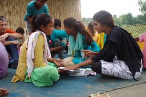 Children study English using the <i>Ollie the Elephant</i> books, at one of the slums in India where Charity United's educational programs are in operation.