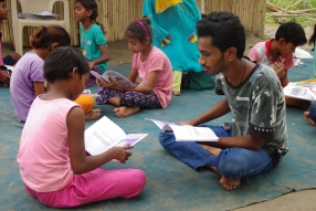 Children study English using the <i>Ollie the Elephant</i> books, at one of the slums in India where Charity United's educational programs are in operation.