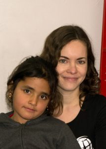 Megan with a refugee child in Greece